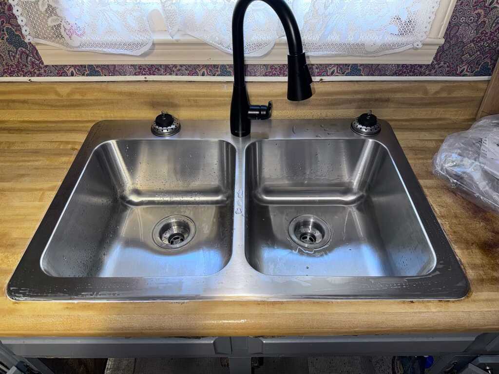 Stainless steel kitchen sink with new black pull-down faucet