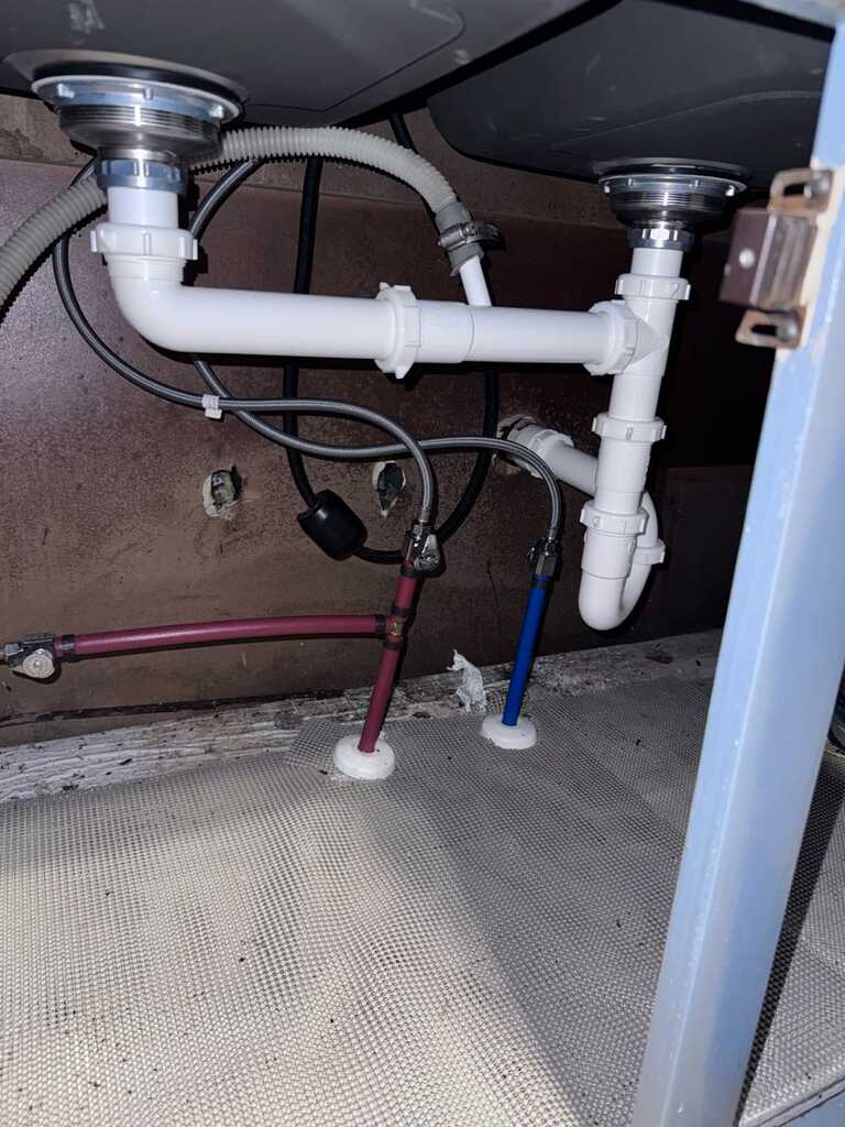 Under-sink plumbing with new supply lines and P-trap